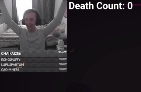 Alex celebrates with his arms in the air