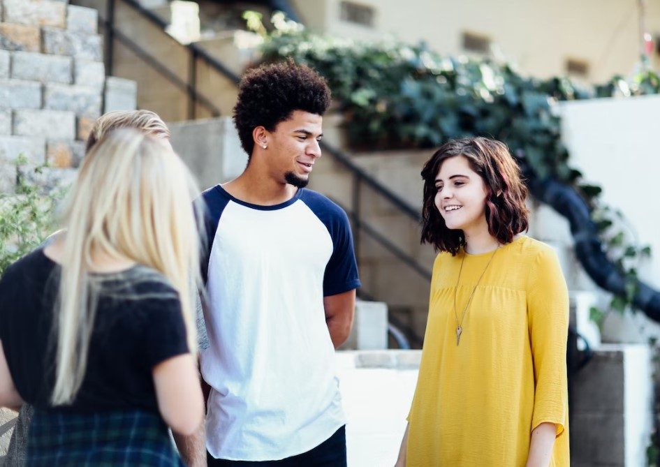 a group of young people stood outside talking