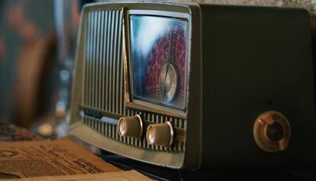 an old school radio by some papers