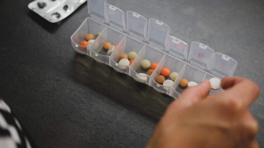 an image of a pill organiser container with various pills inside each day