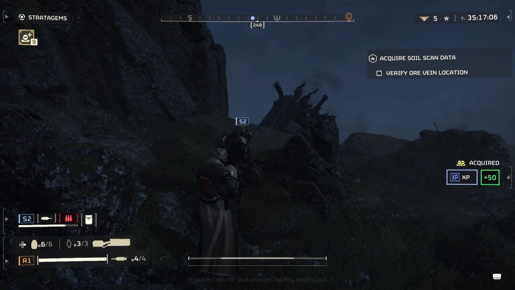 a screenshot from Helldivers II, showing two players traversing a dark rocky landscape with spaceship ruins