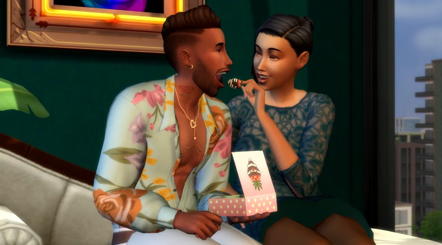 Two Sims from the Sims 4, one is feeding the other a chocolate covered strawberry whilst they sit together.