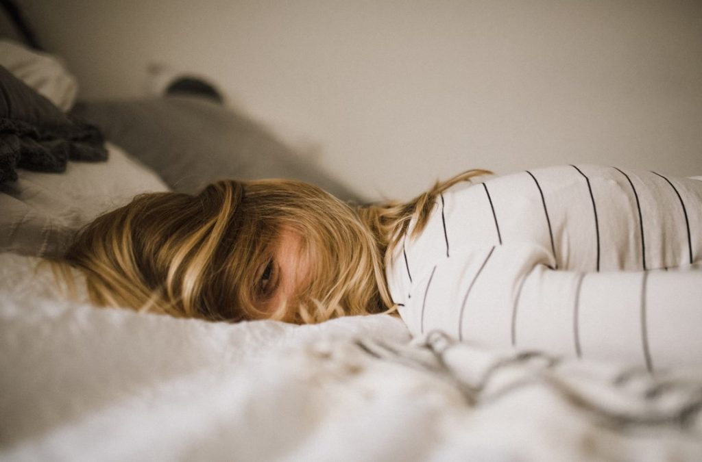 blonde woman lying facedown