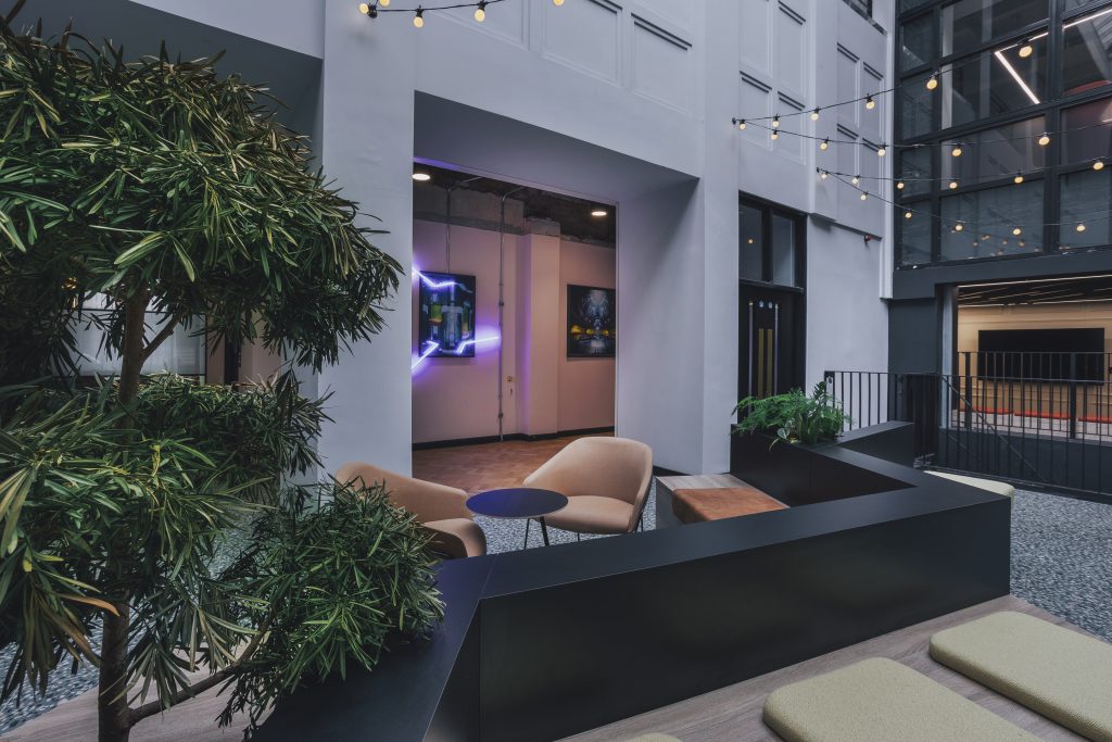 Workplace design example from Claremont, showing a seating area with plants.