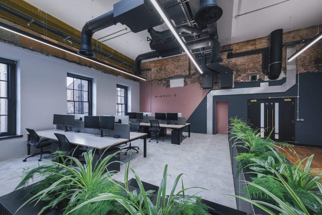 Workplace design example from Claremont, showing more seating spaces with monitors.